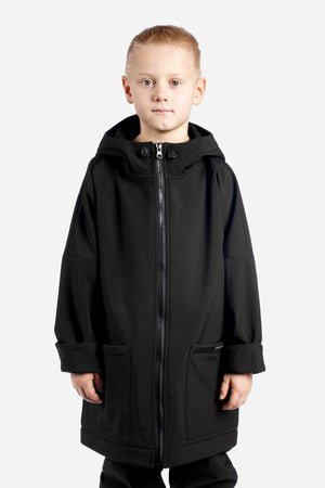 Child wearing a black coat on a white background