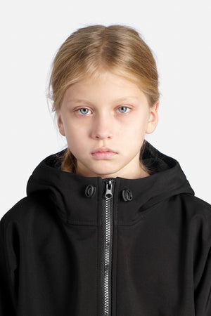 Girl wearing a black jacket with a zipper on a white background