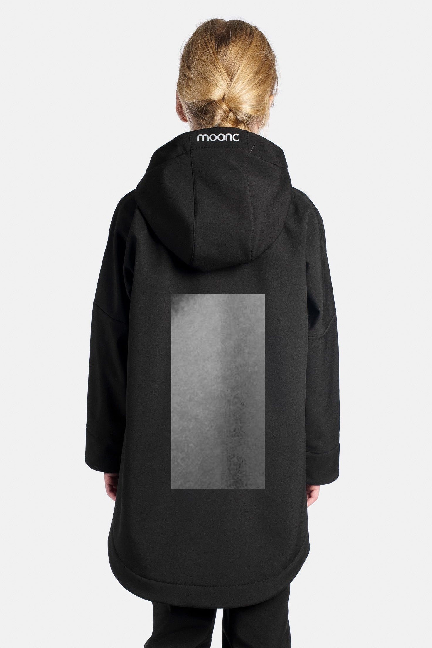 Person wearing a black coat with a hood on a white background