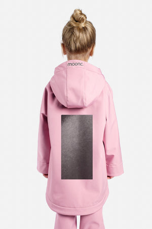 Child wearing a pink onesie with a black square on a white background