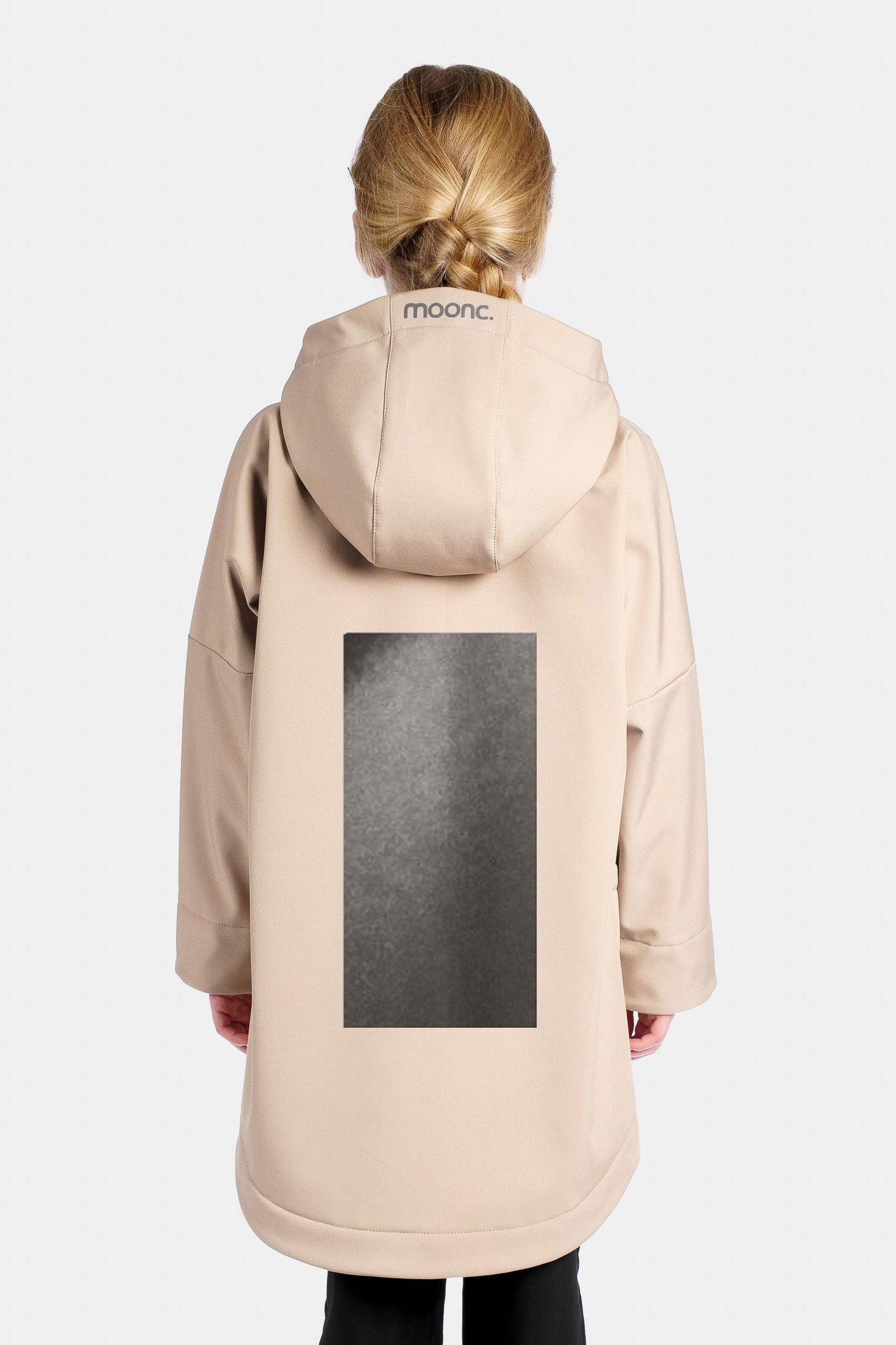 KId wearing a sand rain jacket with a large reflective design.