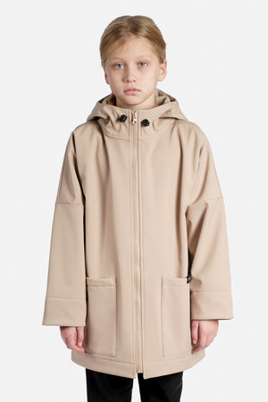 Child wearing a beige rain jacket on a white background