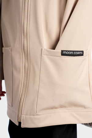 Beige jacket with a visible 'Moon Coats' logo on a white background