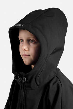 Child wearing a black hooded jacket on a white background