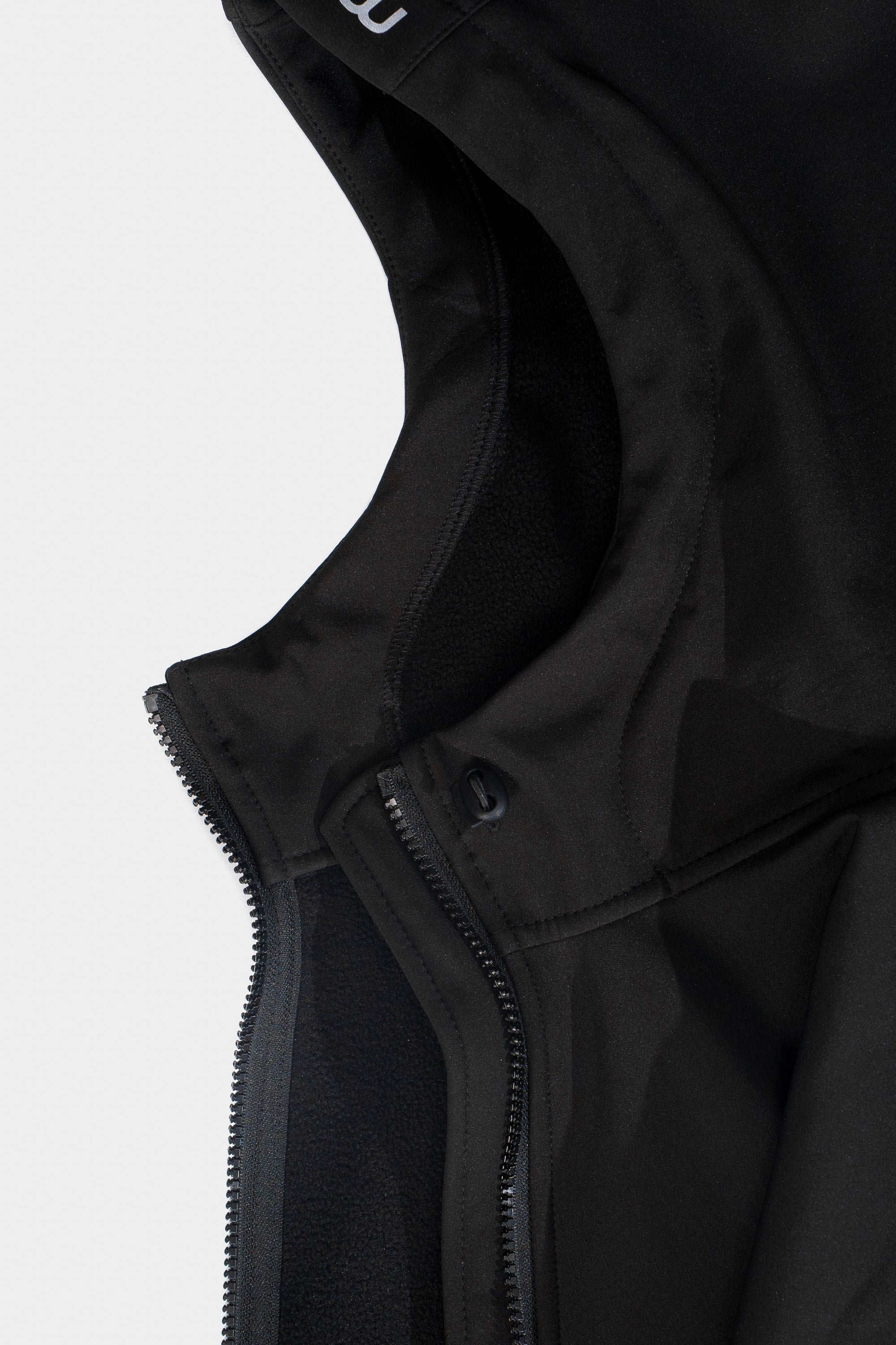Close-up of a black jacket with a zipper on a light gray background