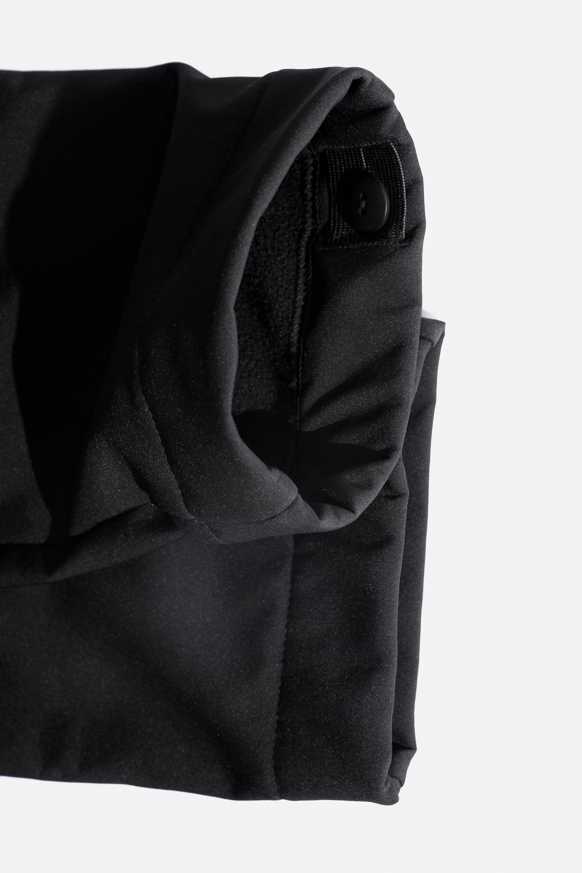 Black softshell trousers adjustable edges on a white background