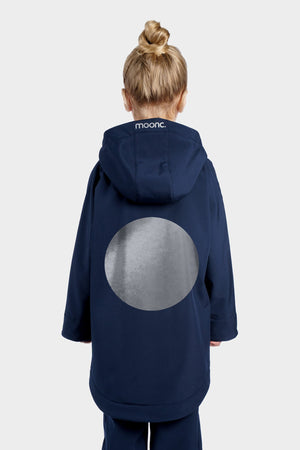 Person wearing a navy blue coat with a gray circle design on the back, standing against a white background.