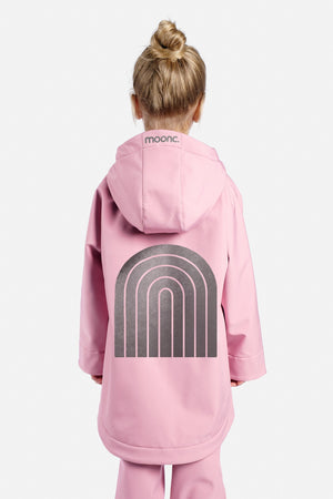 Child wearing a pink onesie with a rainbow design on a white background