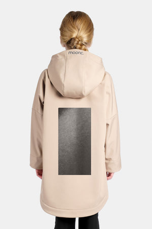 KId wearing a sand rain jacket with a large reflective design.